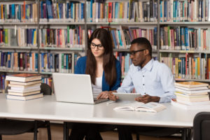 26551959 Couple Of Students With Laptop In Library